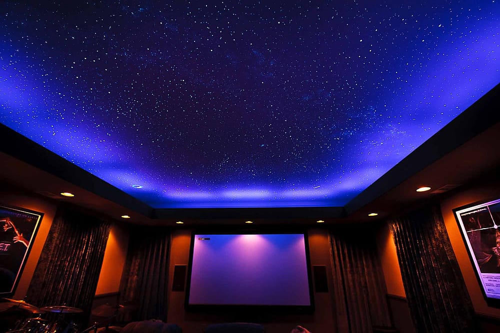 Large home theater with a Night Sky Murals star ceiling, and black lights