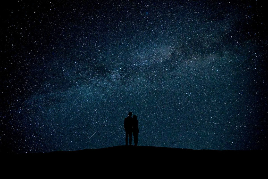 Couple gazing into the night sky